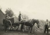 Stenen voor de bouw van de Boschwegse kerk worden door de boeren vervoerd met paard en kar. Wim van Schijndel staat bij het paard met de haverzak. Voor meer details klik hier.